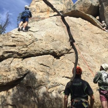 Adventure Plus team rock climbing up steep rocks