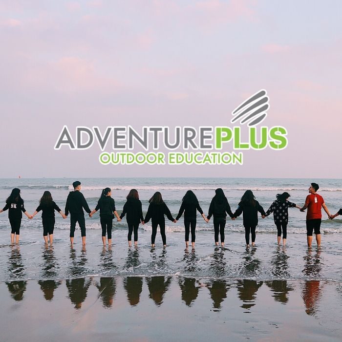Adventure Plus logo with students linking hands
